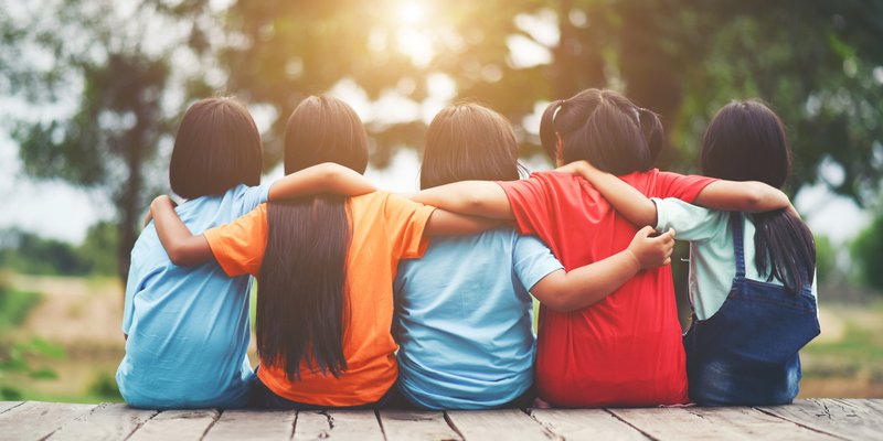 group-of-kids-friends-arm-around-sitting-together.jpg